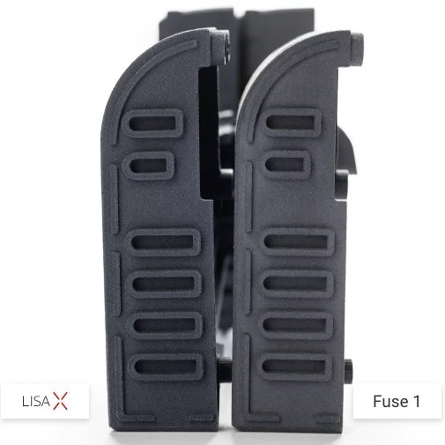 Ribbed covers printed on both machines. Slot edges and wall uniformity are where sintering parameters show up first.